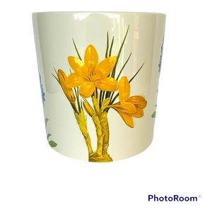 Blossoms & Blooms Planter. White with yellow and blue flowers.